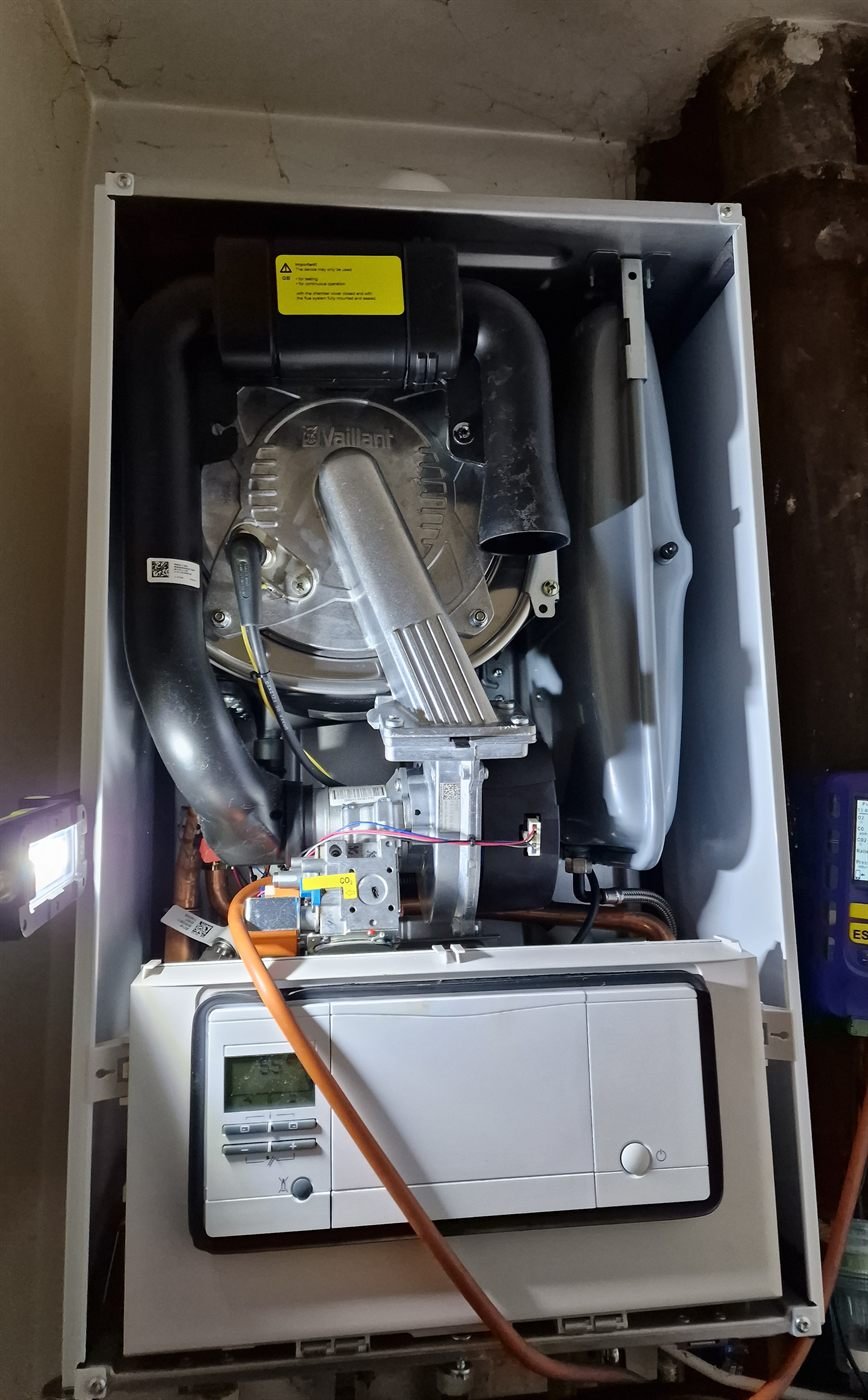 Gas Safe registered engineer servicing a combi boiler
